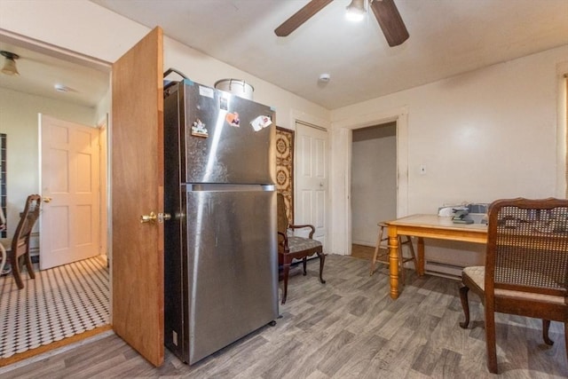 kitchen featuring wood-type flooring, stainless steel fridge, and ceiling fan