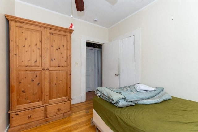 bedroom featuring ornamental molding, ceiling fan, and light hardwood / wood-style flooring