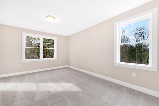 carpeted spare room with baseboards