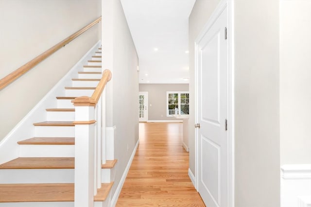 staircase featuring recessed lighting, wood finished floors, and baseboards