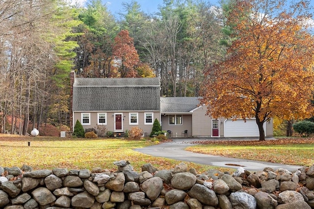 view of front of house with a garage and a front yard