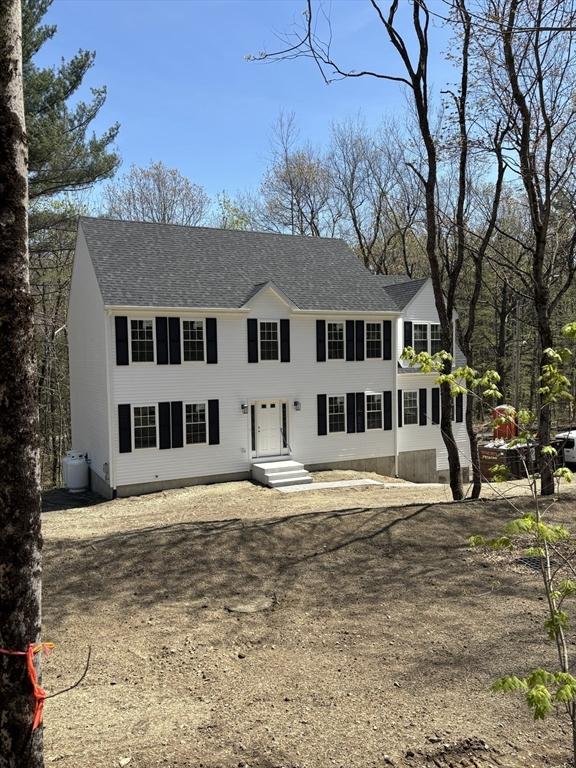 colonial inspired home with a shingled roof