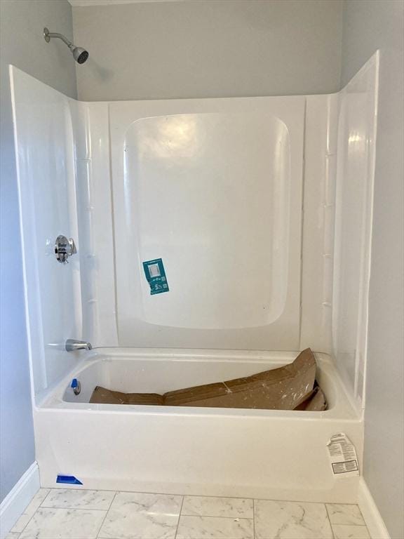 full bath featuring baseboards, marble finish floor, and shower / bath combination