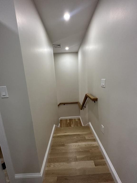 stairs featuring hardwood / wood-style flooring