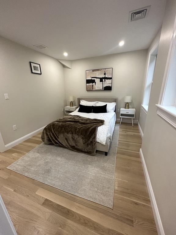 bedroom with wood-type flooring