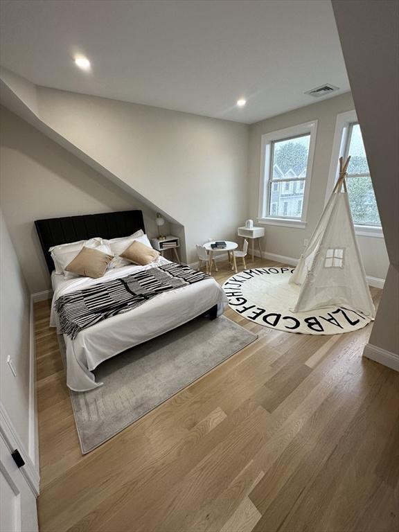 bedroom with hardwood / wood-style flooring