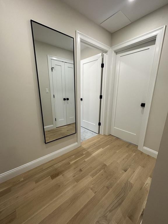 corridor with light wood-type flooring