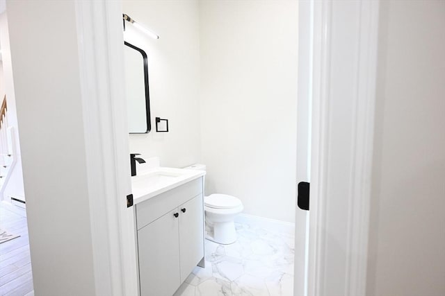 bathroom featuring vanity, a baseboard radiator, and toilet