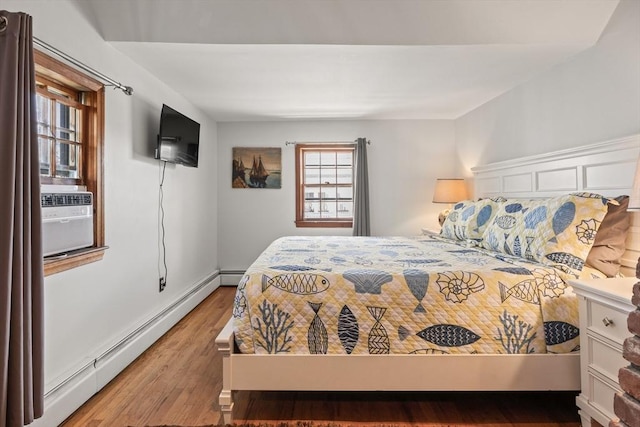 bedroom featuring hardwood / wood-style flooring and a baseboard radiator