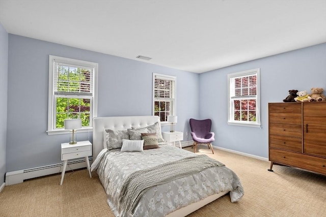 carpeted bedroom featuring baseboard heating