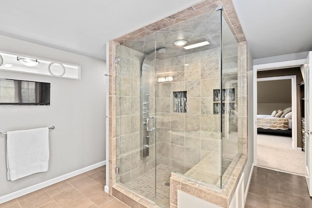 bathroom with a shower with shower door and tile patterned floors