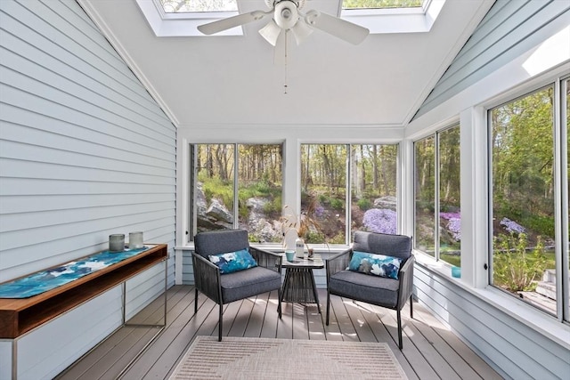 sunroom with lofted ceiling with skylight and ceiling fan