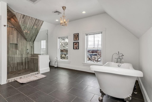 bathroom with visible vents, baseboards, vaulted ceiling, a soaking tub, and a stall shower