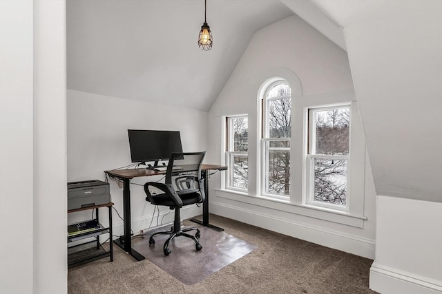 carpeted office featuring vaulted ceiling and baseboards