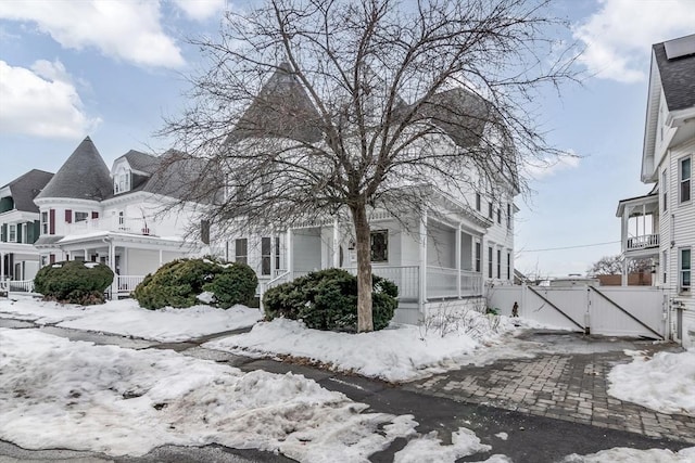 view of front of home with a garage and a gate