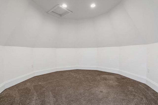 interior space featuring lofted ceiling, recessed lighting, baseboards, dark carpet, and attic access