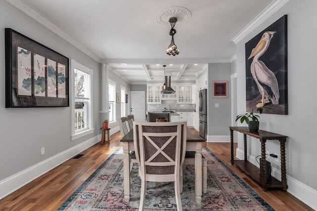 dining room with dark wood-style floors, beam ceiling, coffered ceiling, and baseboards