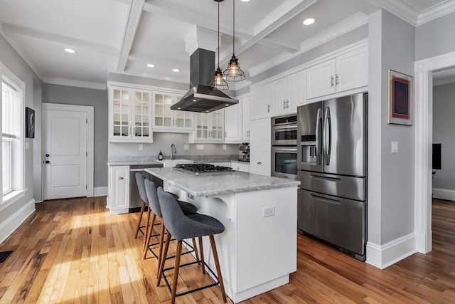 kitchen with white cabinets, a kitchen island, glass insert cabinets, island exhaust hood, and stainless steel appliances