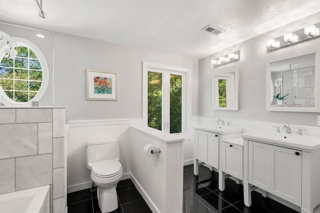 198 Edge Hill Rd, Sharon, MA 02067 - bathroom featuring a wainscoted wall, vanity, toilet, a tub, and tile patterned flooring
