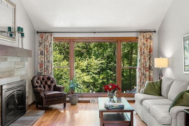 198 Edge Hill Rd, Sharon, MA 02067 - living room with a tiled fireplace, lofted ceiling, and wood finished floors
