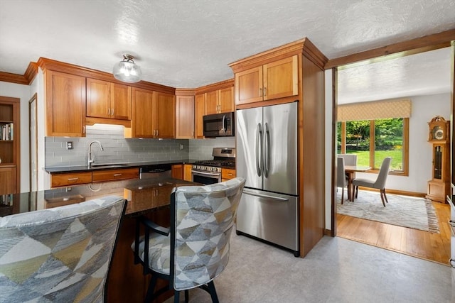 198 Edge Hill Rd, Sharon, MA 02067 - kitchen with appliances with stainless steel finishes, a sink, dark countertops, tasteful backsplash, and brown cabinets