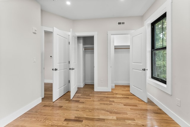 unfurnished bedroom featuring light wood-type flooring