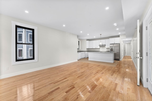 unfurnished living room with light hardwood / wood-style floors