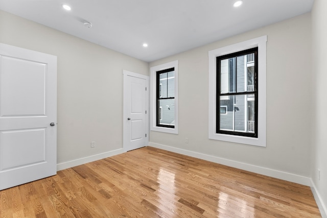 spare room with light hardwood / wood-style flooring