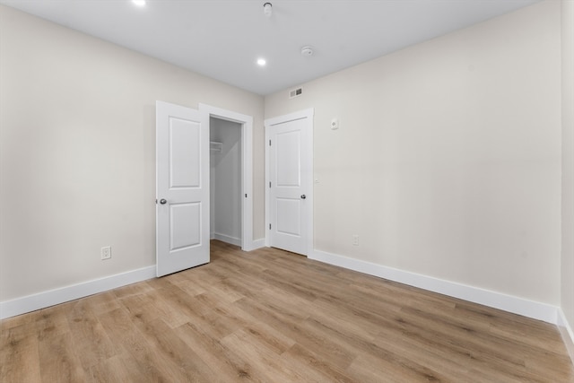 spare room with light hardwood / wood-style floors