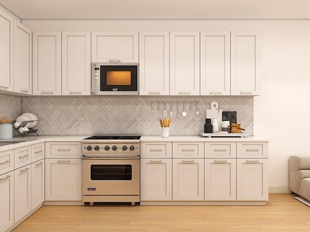 60 Stanley St Unit 102, Boston, MA 02125 - kitchen featuring stainless steel appliances, light countertops, tasteful backsplash, and light wood-type flooring
