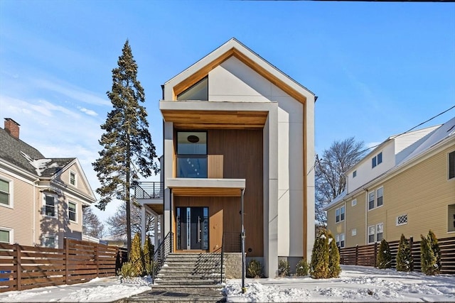 modern home featuring fence