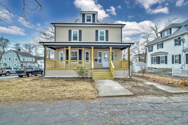 american foursquare style home with covered porch