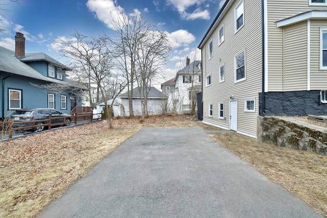 exterior space with aphalt driveway and a residential view