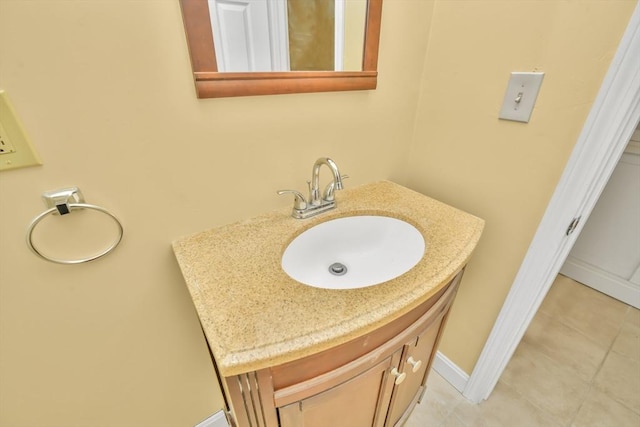 bathroom featuring tile patterned flooring, vanity, and baseboards