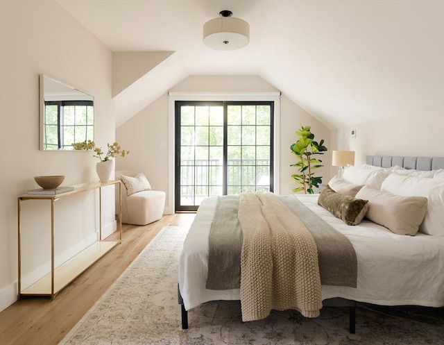 16 Plymouth St Unit 16, Arlington, MA 02476 - bedroom featuring access to outside, vaulted ceiling, and wood finished floors