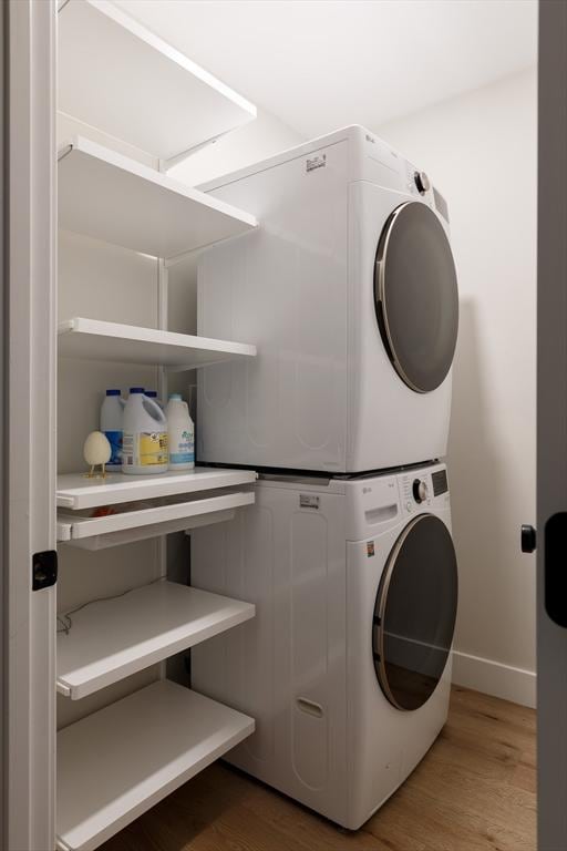 16 Plymouth St Unit 16, Arlington, MA 02476 - washroom with stacked washer / drying machine and wood finished floors