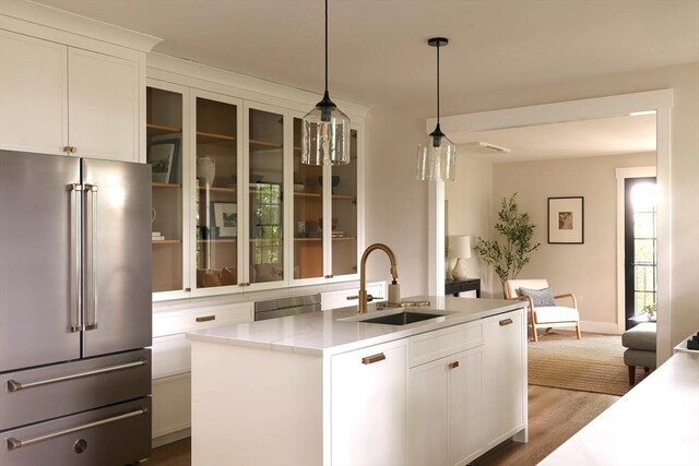 16 Plymouth St Unit 16, Arlington, MA 02476 - kitchen with high end refrigerator, a kitchen island with sink, dark wood-style flooring, open floor plan, and white cabinets