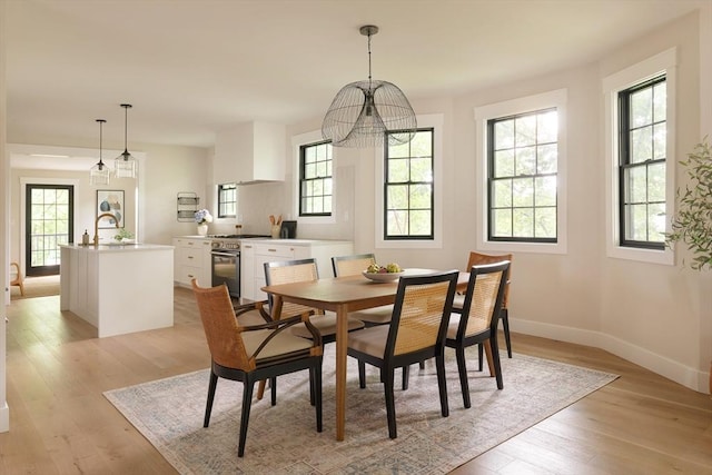 16 Plymouth St Unit 16, Arlington, MA 02476 - dining room with plenty of natural light, light wood-style floors, and a chandelier