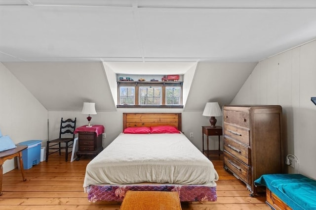 bedroom featuring light wood-type flooring and lofted ceiling
