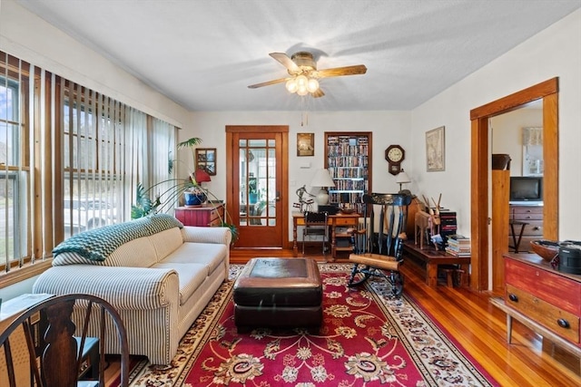 living area with ceiling fan and wood finished floors