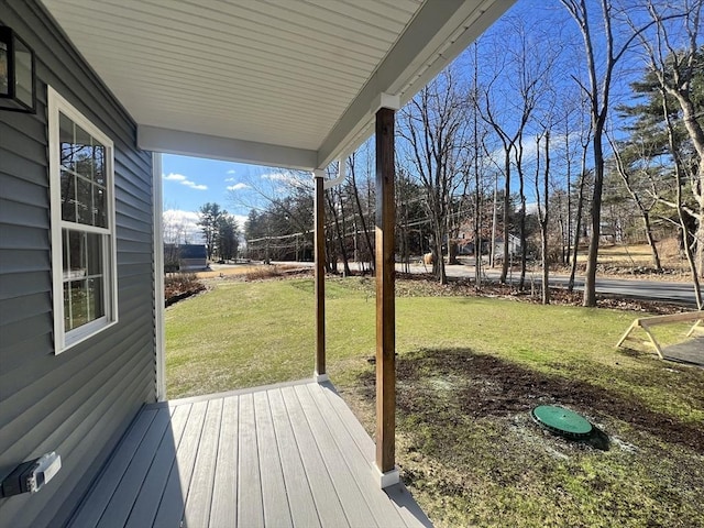 deck with a porch and a yard