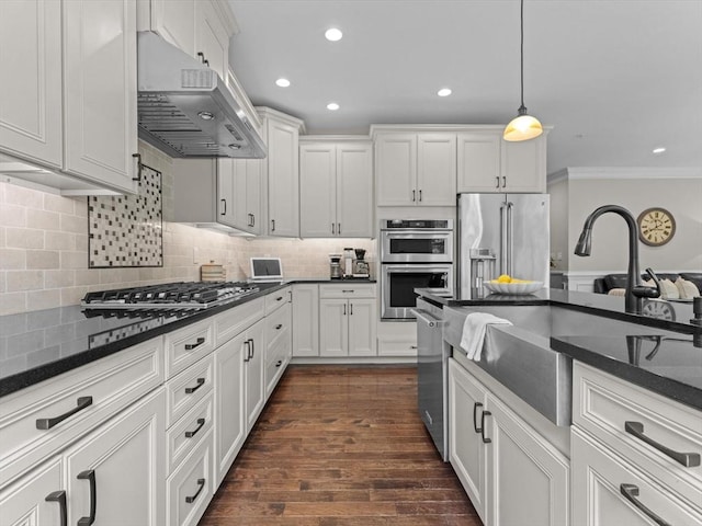 79 Townsend Blvd Unit 79, Westborough, MA 01581 - kitchen featuring range hood, appliances with stainless steel finishes, crown molding, decorative backsplash, and white cabinetry
