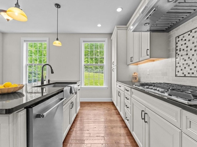 79 Townsend Blvd Unit 79, Westborough, MA 01581 - kitchen featuring appliances with stainless steel finishes, wall chimney exhaust hood, plenty of natural light, hardwood / wood-style flooring, and recessed lighting