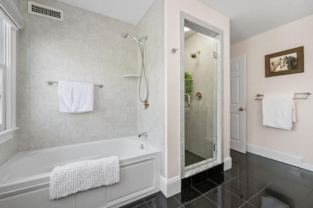 bathroom featuring tile patterned flooring and plus walk in shower