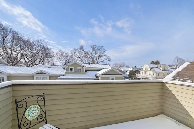 view of snow covered back of property