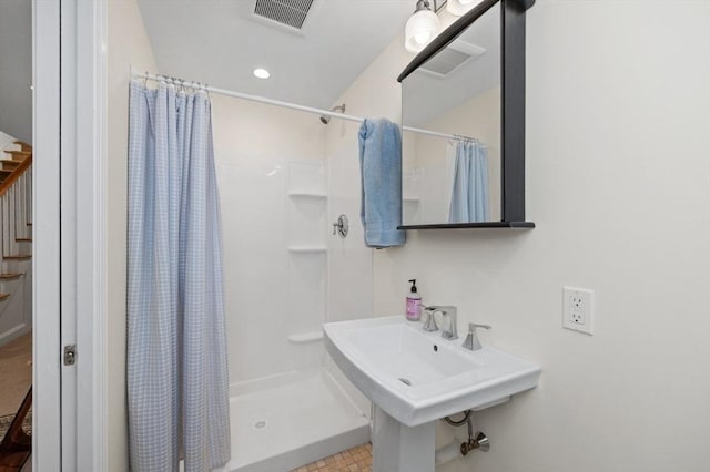 bathroom with sink and a shower with shower curtain