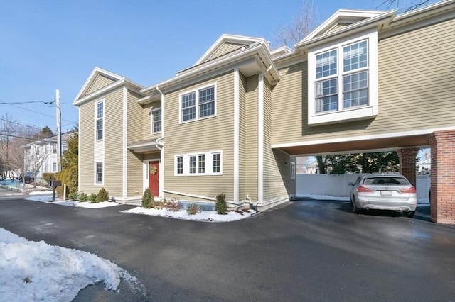 townhome / multi-family property featuring a carport