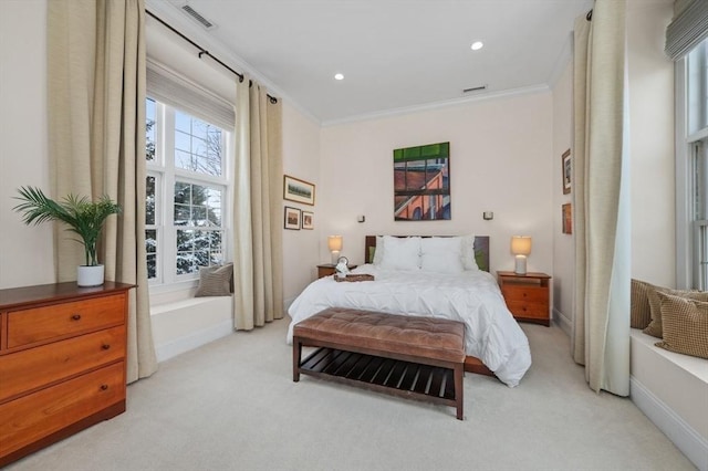 bedroom with crown molding and light colored carpet