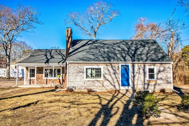 back of property featuring covered porch and a yard