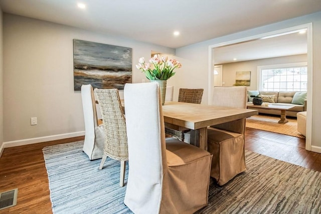 dining space with dark hardwood / wood-style floors